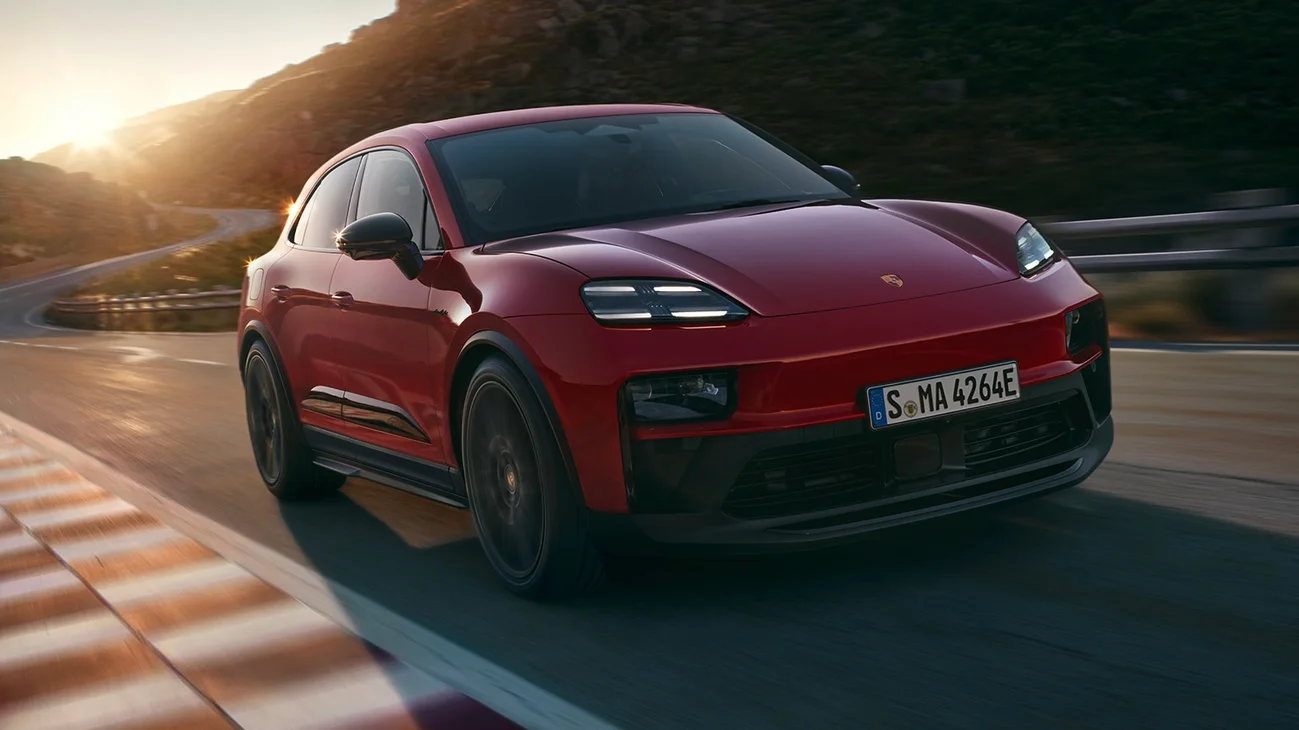 Front shot of a Macan GTS driving on a road in the countryside.