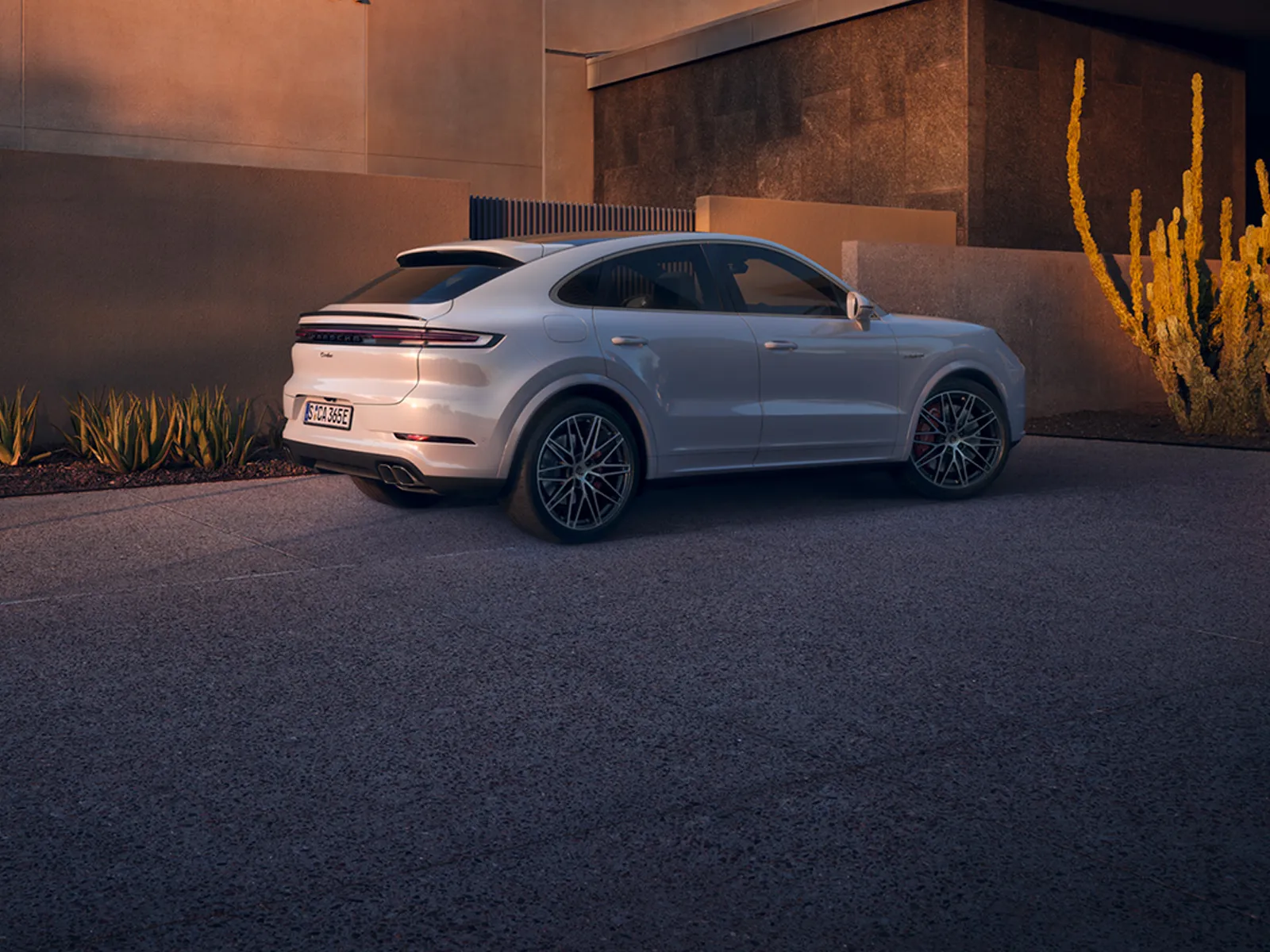 Cayenne parked in urban environment during sunset hour.