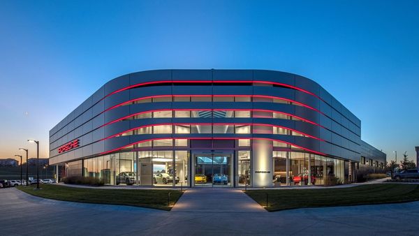 A picture of a Porsche Center at dusk
