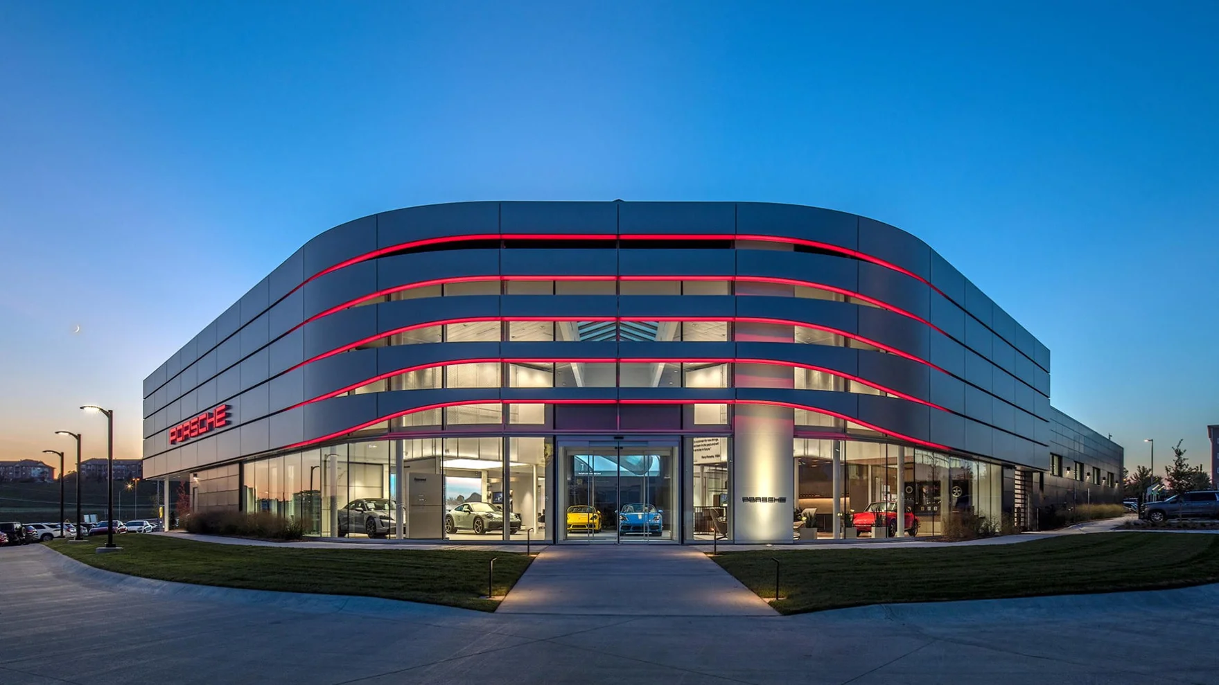 A picture of a Porsche Center at dusk