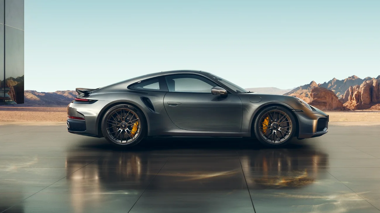 Side shot of a 911 Turbo S with mountains in the background.