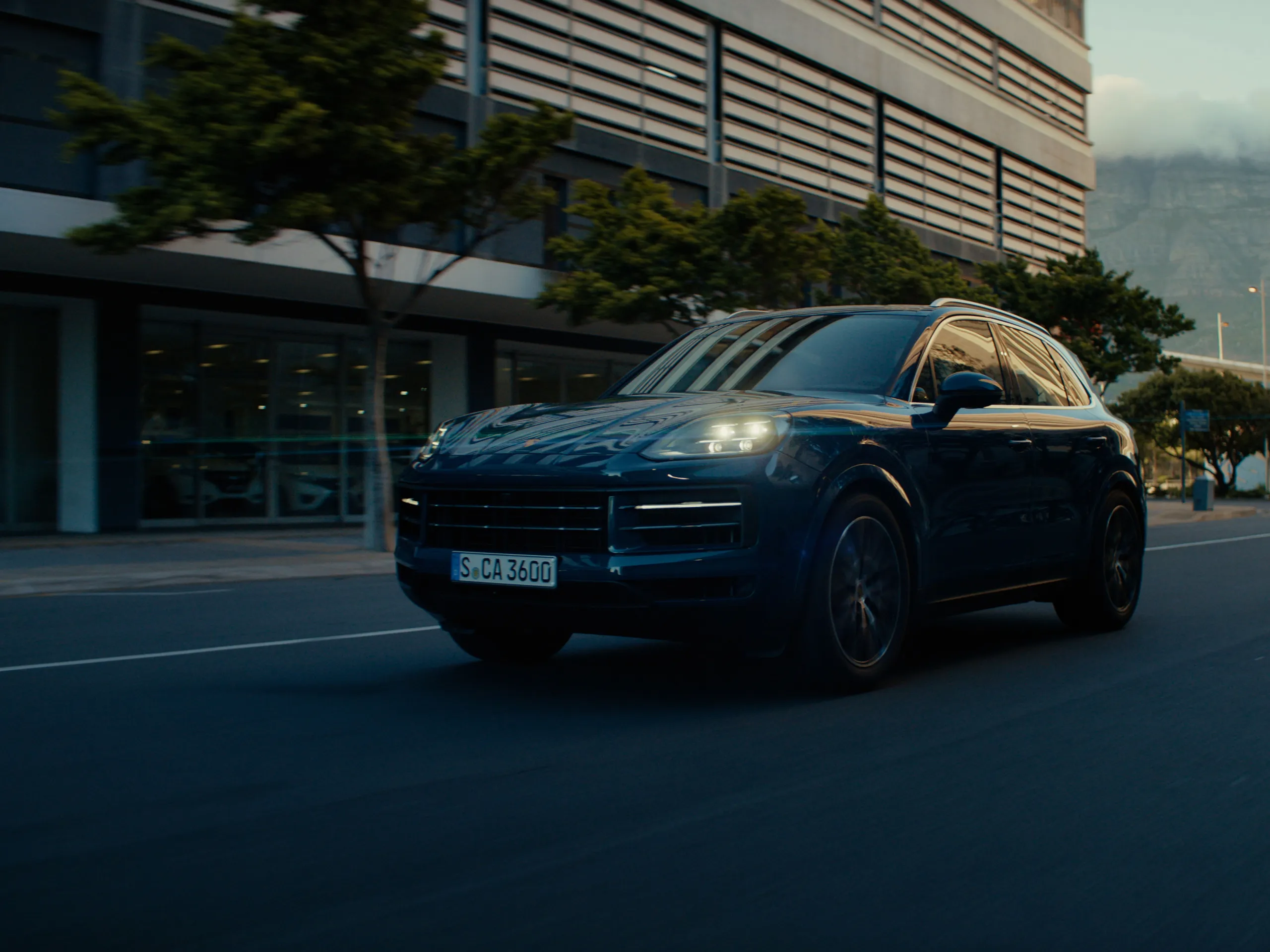 Several dynamic shots of a Cayenne drving threw the city.